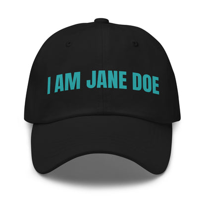 Black cap with 'I AM JANE DOE' embroidered in teal thread on a white background