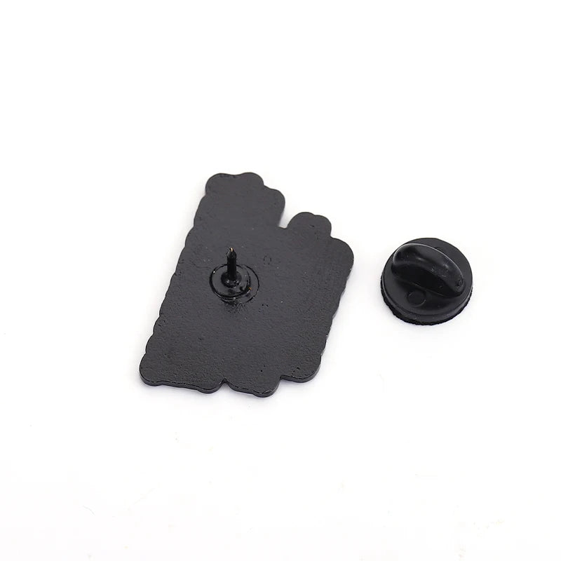 Black rubber pin clutch and the back of an enamel pin on a white background