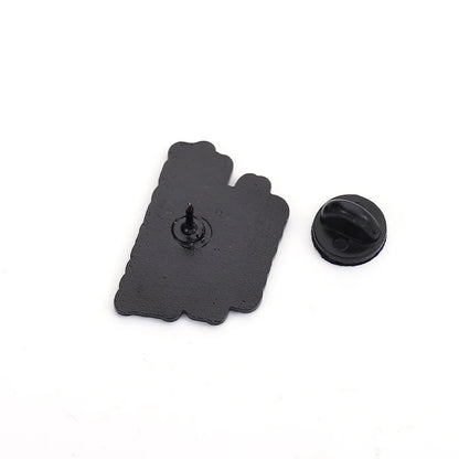 Black rubber pin clutch and the back of an enamel pin on a white background