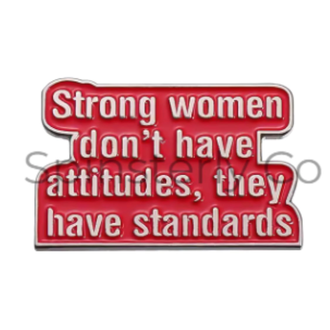 A red enamel pin with white text that reads 'Strong women don't have attitudes, they have standards' on a plain white background.