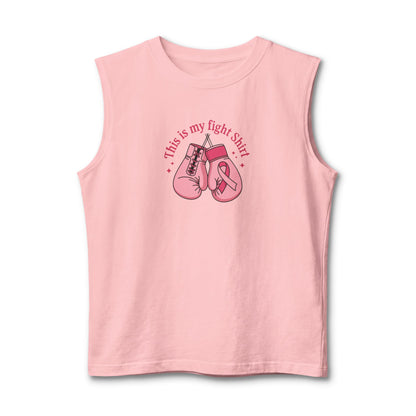 A light pink sleeveless muscle tank top featuring a graphic of pink boxing gloves and a pink ribbon with the text 'This is my fight shirt' printed on the chest, displayed against a plain white background.