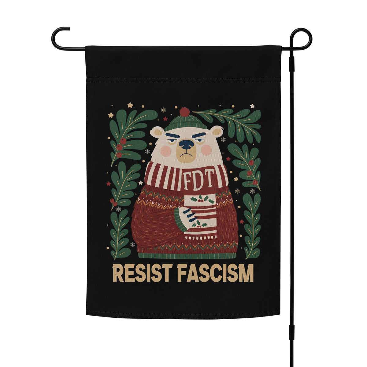 A black garden flag hanging on a black metal stand, featuring a cartoon bear wearing a green hat and a red-and-white striped sweater with 'FDT' on it, surrounded by green leaves and the text 'RESIST FASCISM' at the bottom.