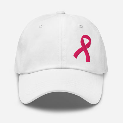 A white baseball cap featuring an embroidered pink breast cancer awareness ribbon on the front right side, set against a clean light gray background.