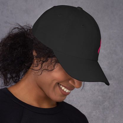 Person wearing a black cap against a gray background