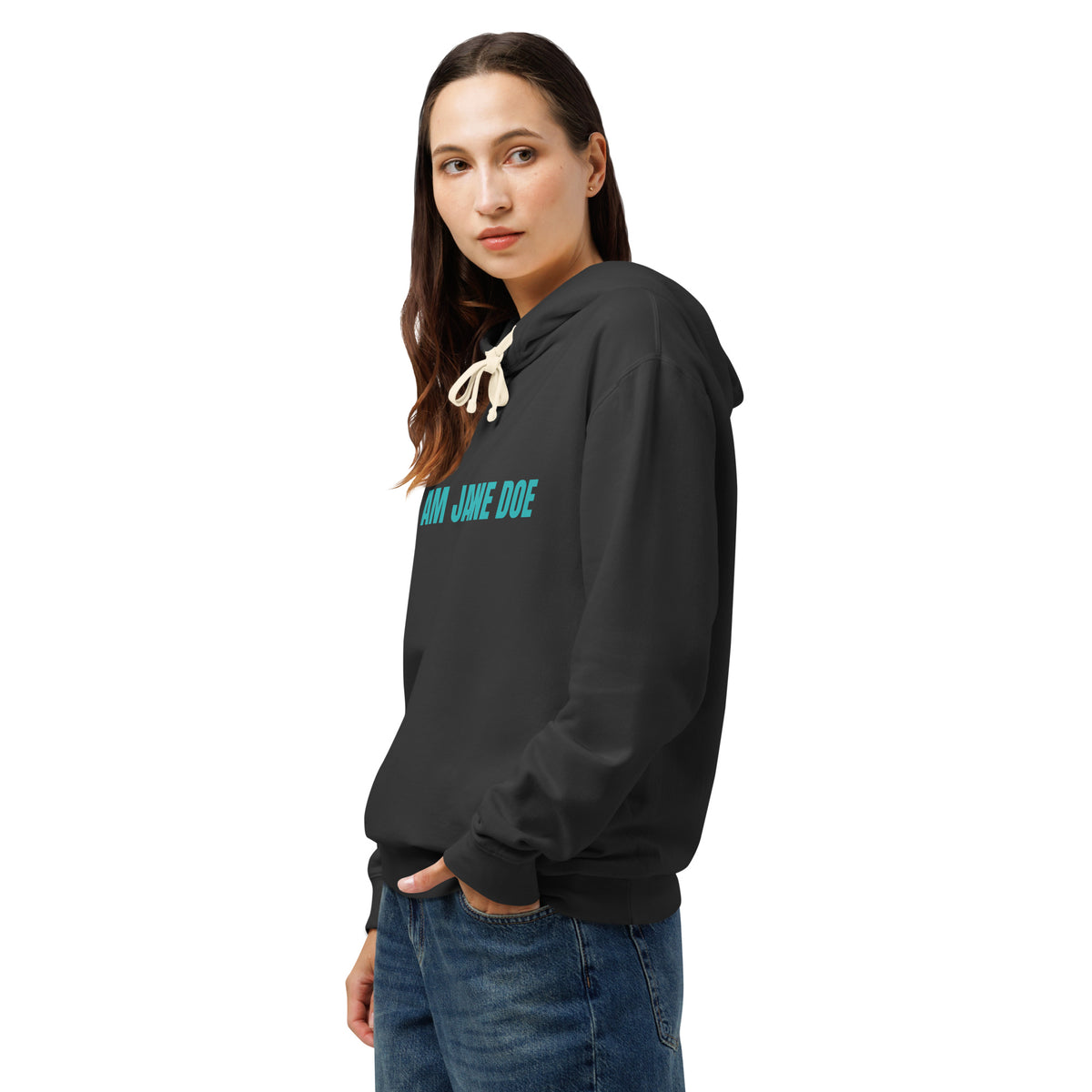 A woman wearing a black pullover hoodie with 'I AM JAME DOE' printed in teal across the chest, paired with blue jeans, shown against a plain white background.