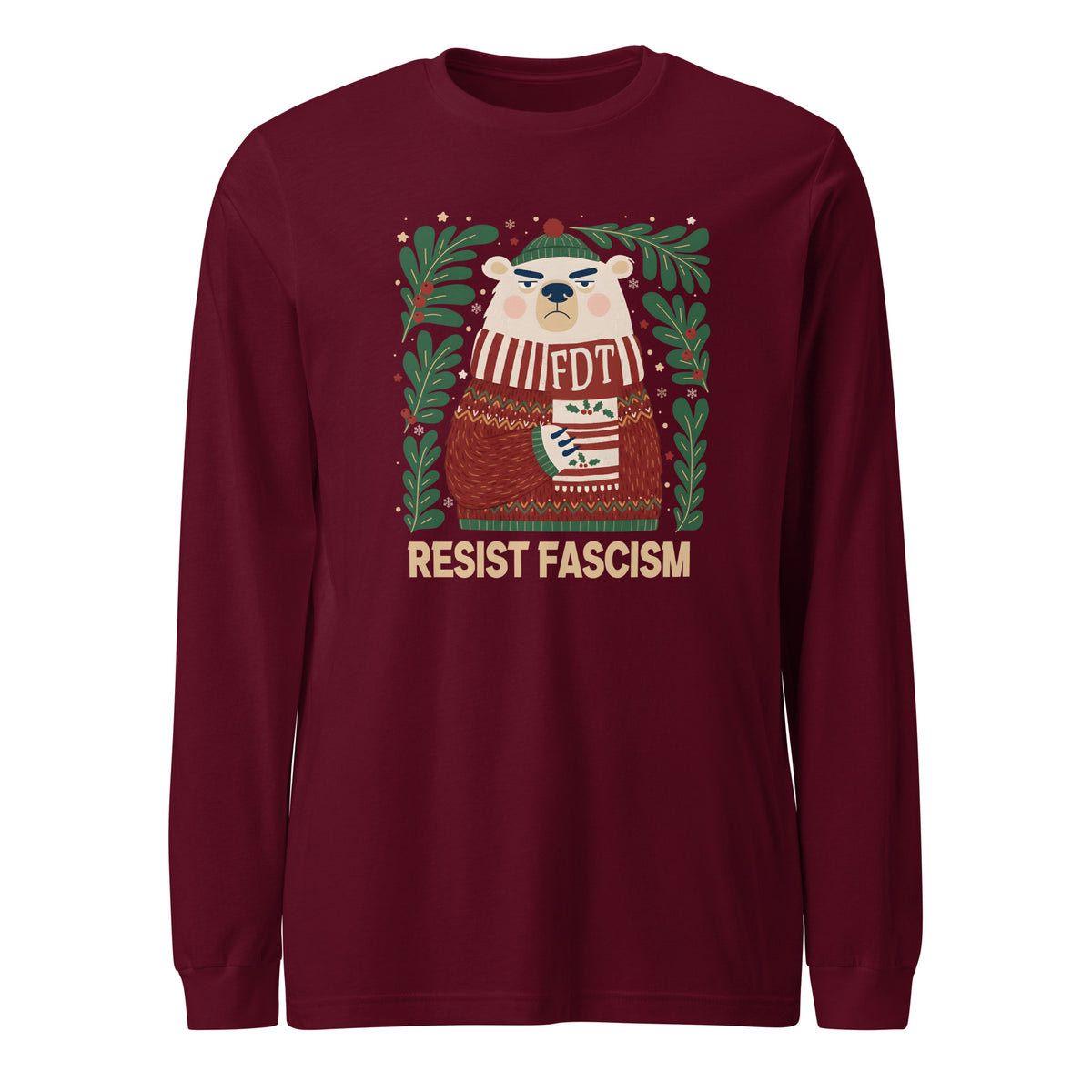 A long-sleeve crewneck t-shirt in maroon, featuring a festive graphic of a polar bear wearing a striped sweater and hat, surrounded by green pine branches, with the text 'RESIST FASCISM' printed below in beige.