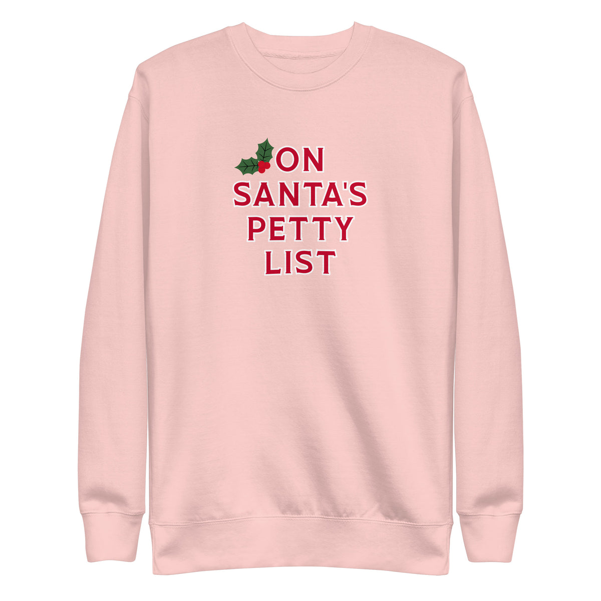 A light pink crewneck sweatshirt featuring the text 'ON SANTA'S PETTY LIST' in red, with a small green holly graphic at the top left of the text, shown on a plain white background.